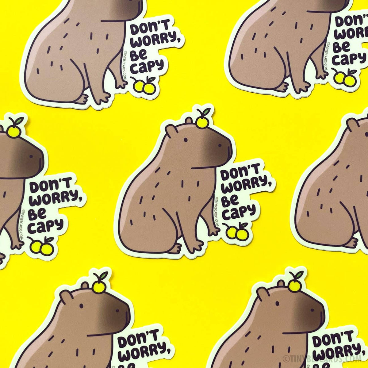 Don't Worry Be Capy vinyl stickers featuring a capybara with yuzu fruit on yellow background
